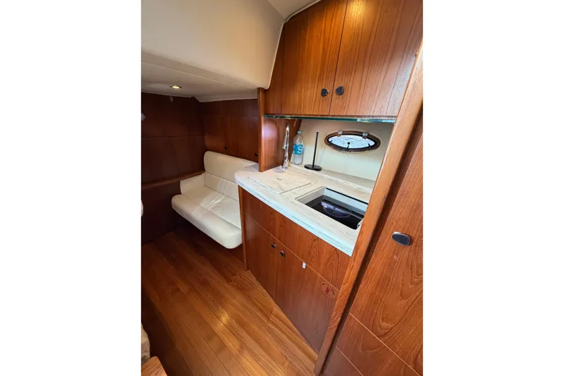 Slide: The Image of Interior of 2013 Tiara Yachts 3600 Coronet with wood cabinetry and white seating. - 4