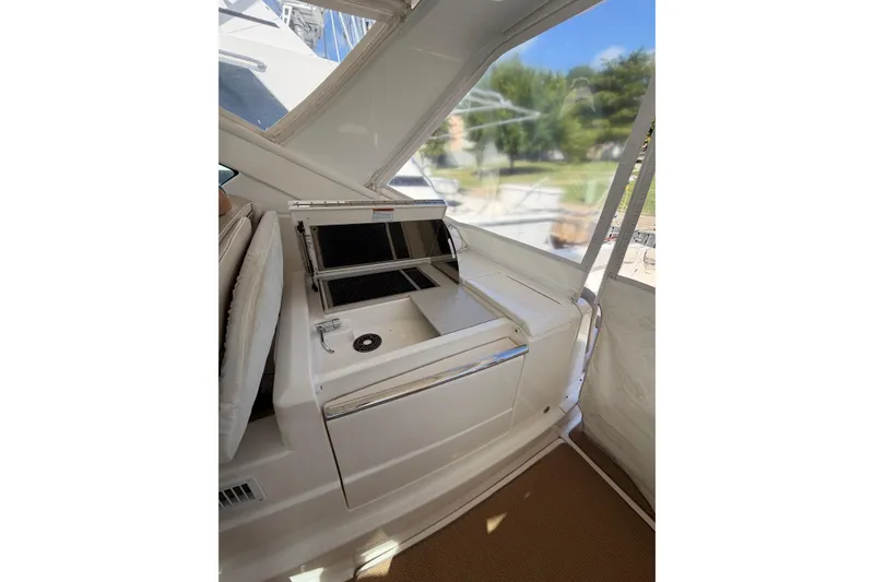 Slide: The Image of 2013 Tiara Yachts 3600 Coronet interior with kitchenette and seating area. - 9