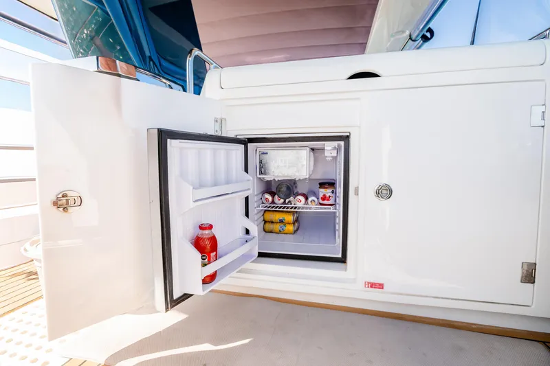 Slide: The Image of Mini fridge on 2023 Sirena 58 yacht, stocked with beverages and snacks. - 13