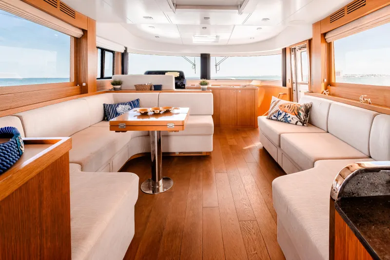 Slide: The Image of Luxurious interior of 2023 Sirena 58 yacht with elegant wood and plush seating. - 16