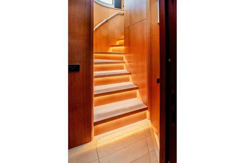 Slide: The Image of Illuminated wooden staircase inside 2023 Sirena 58 yacht, showcasing modern design and elegance. - 22