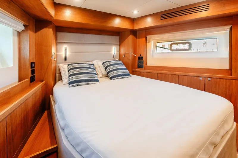 Slide: The Image of Luxurious cabin interior of 2023 Sirena 58 yacht with cozy bed and wooden finish. - 26