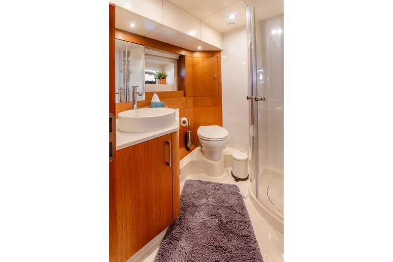 Slide: The Image of Luxurious bathroom in 2023 Sirena 58 yacht with modern fixtures and wooden cabinetry. - 27