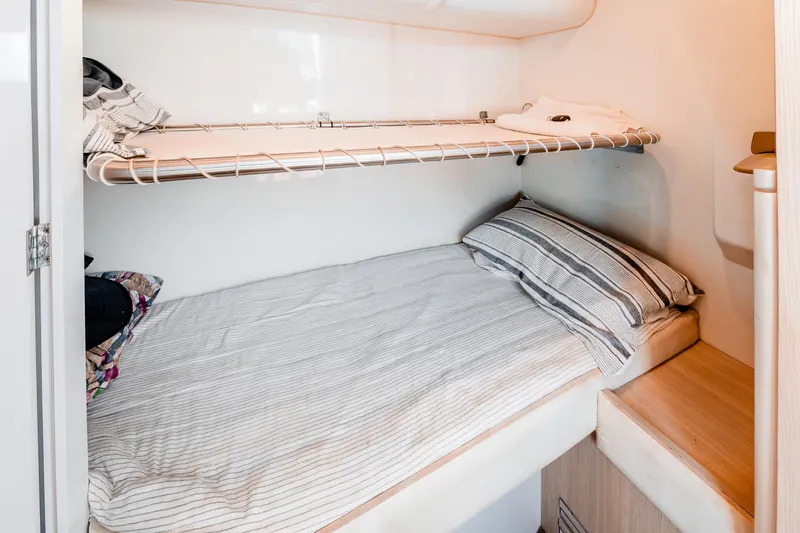 Slide: The Image of Cozy cabin bed with striped bedding in 2023 Sirena 58 yacht interior. - 31