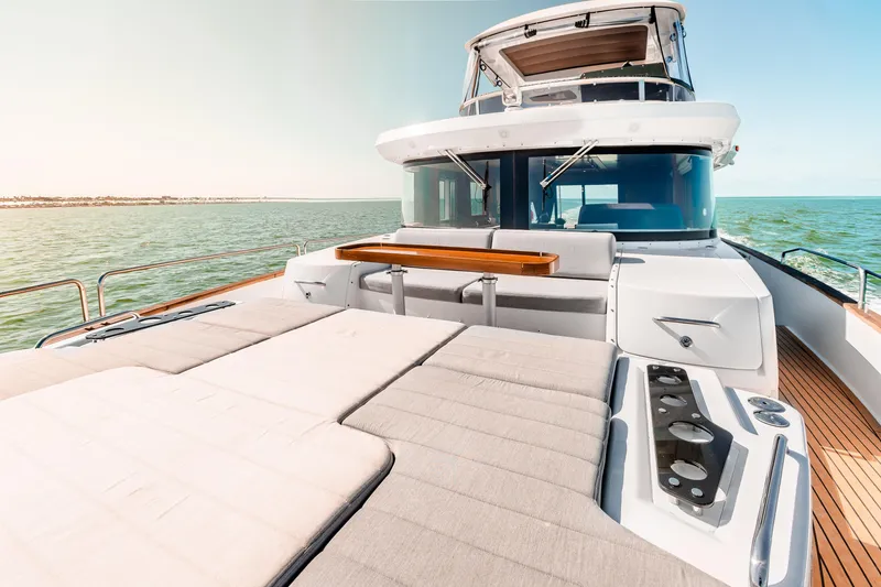 Slide: The Image of Luxurious 2023 Sirena 58 yacht deck with sunbeds and ocean view. - 4