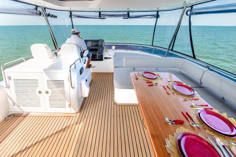 Slide: The Image of Luxurious 2023 Sirena 58 yacht interior with dining setup and ocean view. - 7