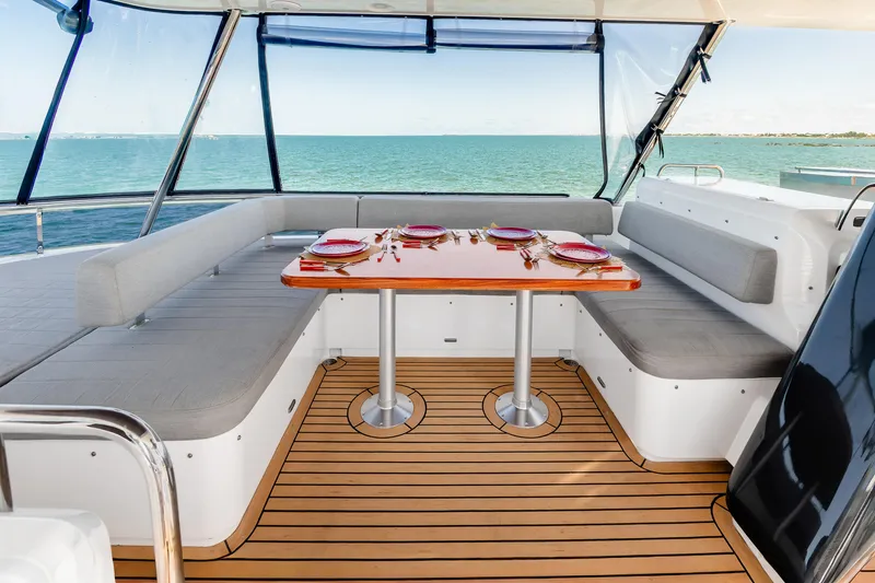 Slide: The Image of Luxurious 2023 Sirena 58 yacht interior with elegant dining setup and ocean view. - 8