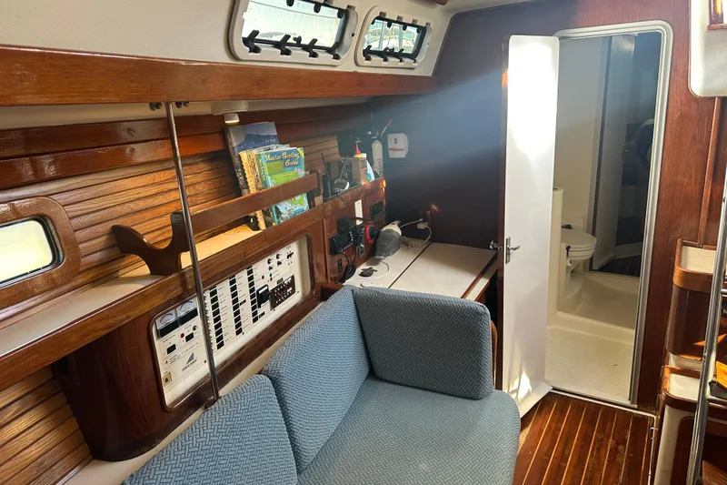Slide: The Image of Interior of 1994 Catalina Morgan 38 sailboat with cozy seating and navigation equipment. - 13