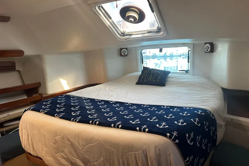 Slide: The Image of Cozy cabin interior of 1994 Catalina Morgan 38 sailboat with nautical-themed bedding. - 14