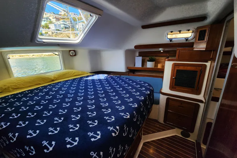 Slide: The Image of Cozy cabin interior of 1994 Catalina Morgan 38 sailboat with nautical-themed bedding. - 15