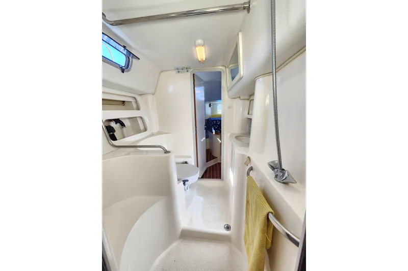 Slide: The Image of 1994 Catalina Morgan 38 yacht bathroom with shower, sink, and towel rack. - 16
