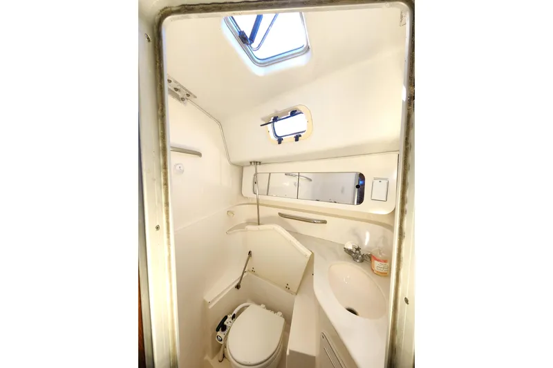 Slide: The Image of Compact bathroom in 1994 Catalina Morgan 38 sailboat with toilet, sink, and mirror. - 18