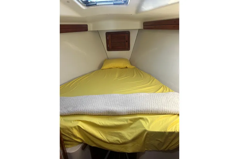 Slide: The Image of Cozy cabin interior of 1994 Catalina Morgan 38 sailboat with yellow bedding. - 19
