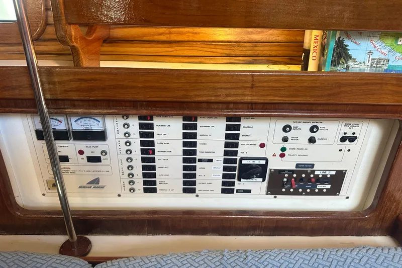 Slide: The Image of Control panel of a 1994 Catalina Morgan 38 sailboat, featuring various switches and gauges. - 22