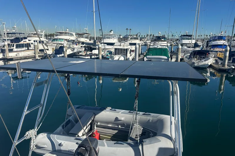 Slide: The Image of Sailboat marina view with Catalina Morgan 38, featuring solar panels and inflatable dinghy. - 24