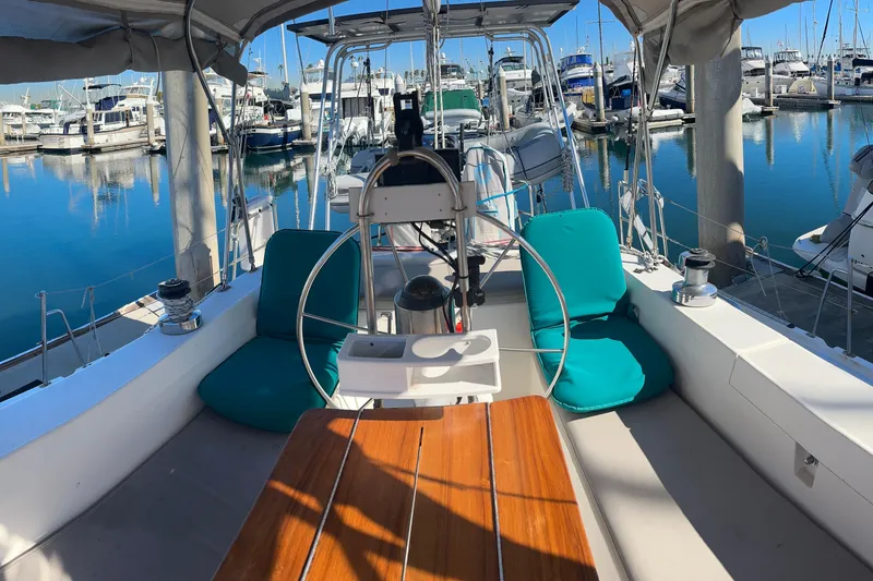 Slide: The Image of Cockpit of 1994 Catalina Morgan 38 sailboat docked at marina with turquoise cushions. - 3