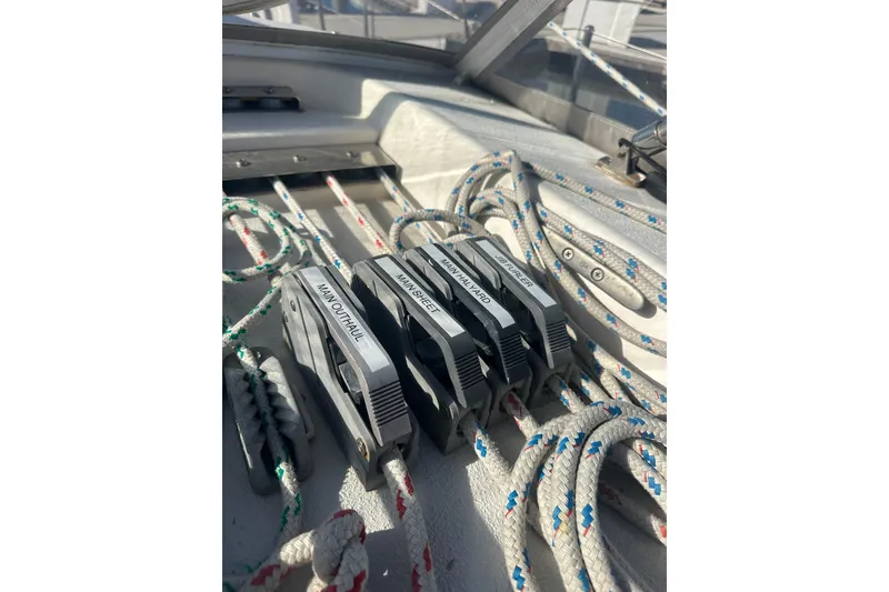 Slide: The Image of Sailboat rigging on a 1994 Catalina Morgan 38, featuring labeled rope clutches. - 8