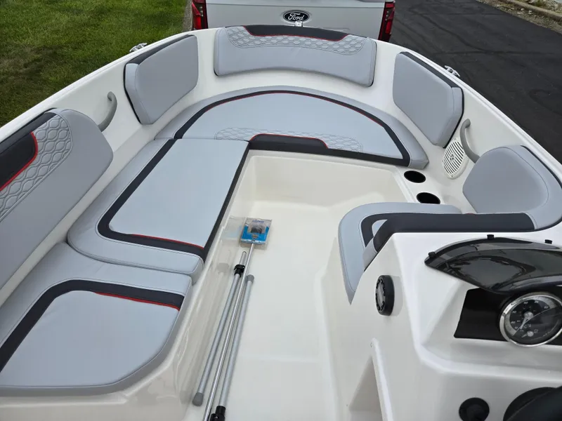 Slide: The Image of 2022 Bayliner Element M15 boat interior with gray seating and steering console. - 12