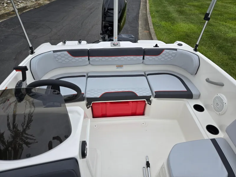 Slide: The Image of 2022 Bayliner Element M15 boat interior with seating and steering wheel. - 17