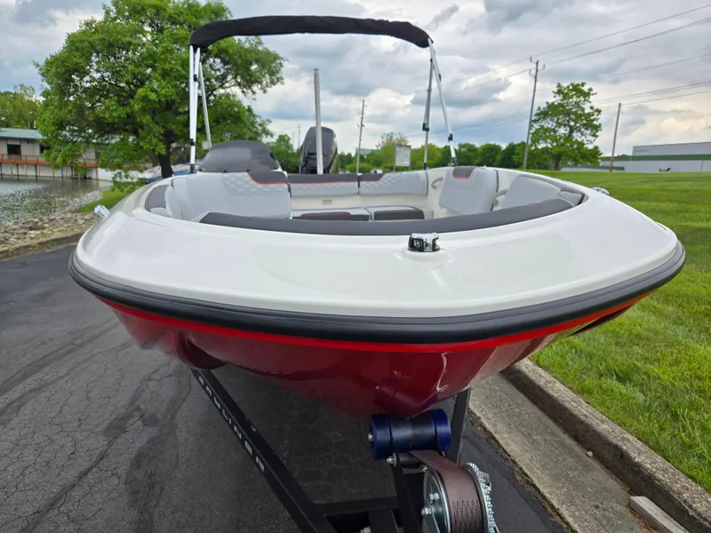 Slide: The Image of 2022 Bayliner Element M15 boat on trailer, parked near water and greenery. - 6