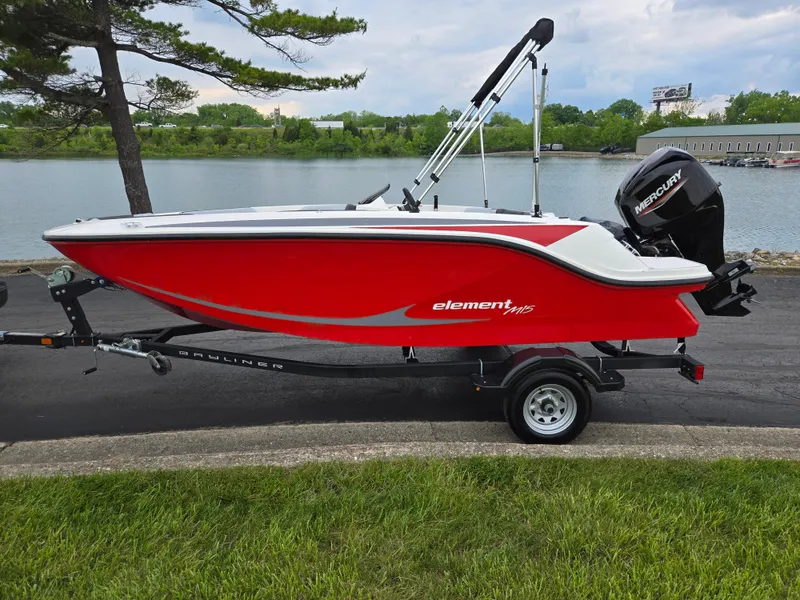 Slide: The Image of 2022 Bayliner Element M15 boat in red, parked by a lakeside on a trailer. - 9