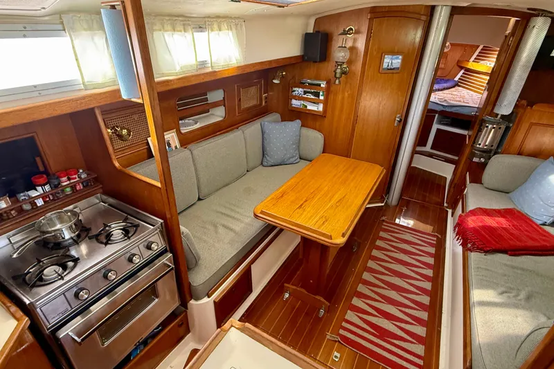 Slide: The Image of Cozy 1985 Niagara Encore yacht interior with kitchen, seating, and wooden accents. - 10