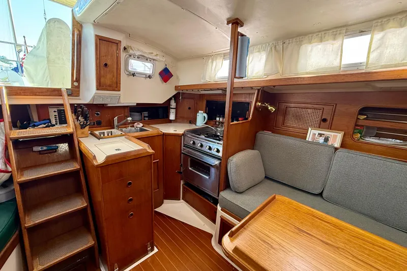 Slide: The Image of Interior of 1985 Niagara Encore sailboat with kitchen and seating area. - 11