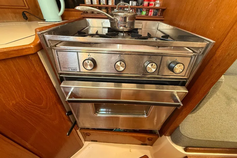 Slide: The Image of 1985 Niagara Encore kitchen with stainless steel stove and oven, wooden cabinetry. - 13