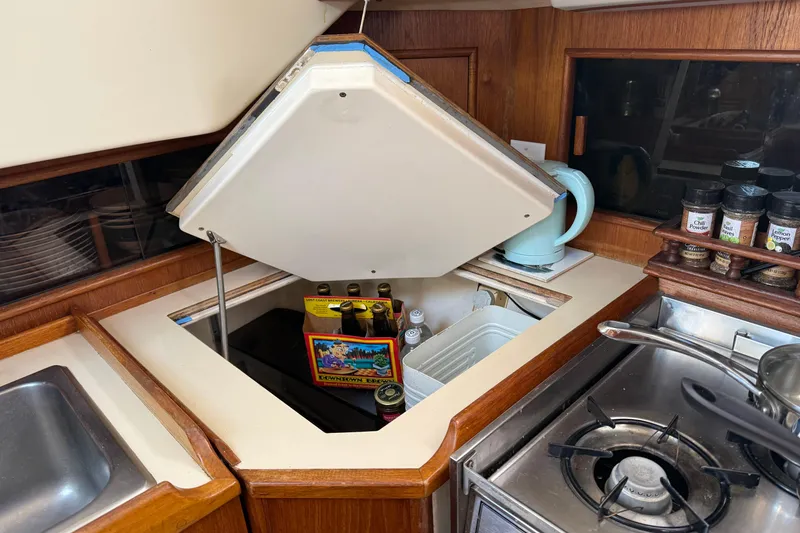 Slide: The Image of 1985 Niagara Encore yacht kitchen with open storage, spices, and stove. - 15