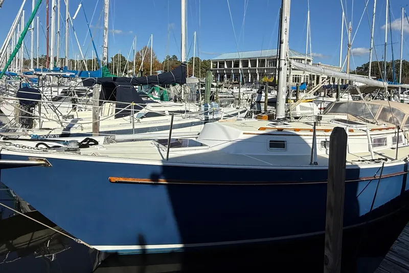 Slide: The Image of 1985 Niagara Encore sailboat docked at a marina under clear blue skies. - 2