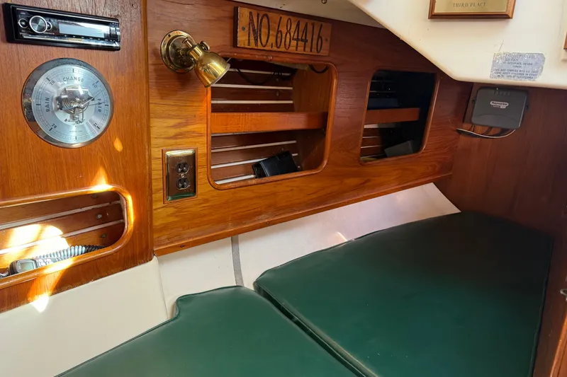 Slide: The Image of Interior of 1985 Niagara Encore boat with wood paneling and green cushions. - 24