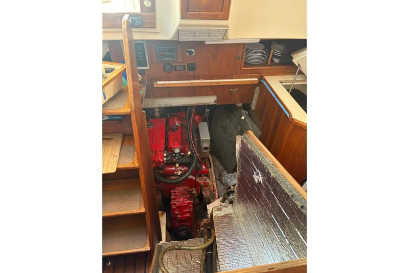 Slide: The Image of Engine compartment of 1985 Niagara Encore sailboat with red engine and wooden interior. - 27