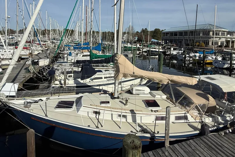 Slide: The Image of Sailboats docked at a marina, featuring a 1985 Niagara Encore model. - 3