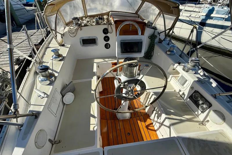 Slide: The Image of 1985 Niagara Encore sailboat cockpit with wooden flooring and steering wheel. - 5