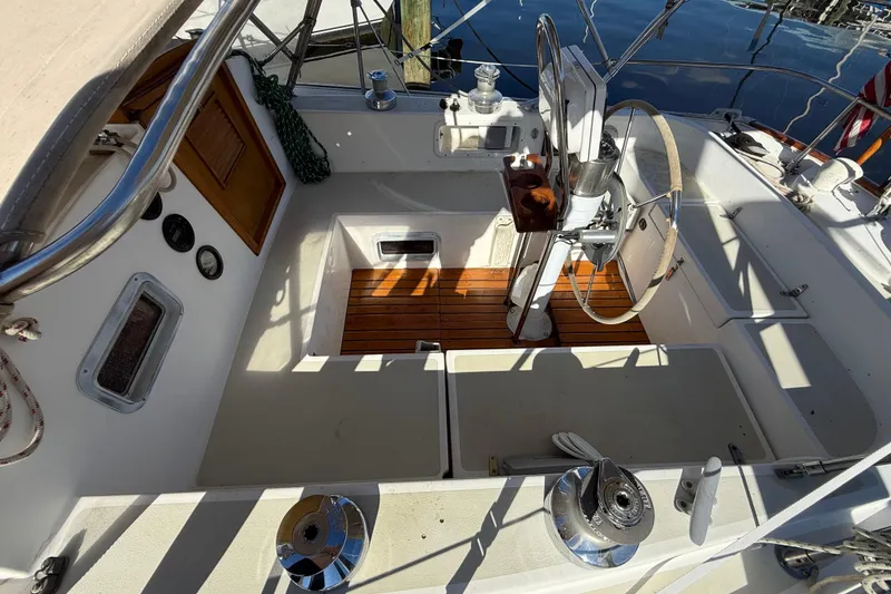 Slide: The Image of 1985 Niagara sailboat cockpit with wooden flooring and steering wheel. - 6