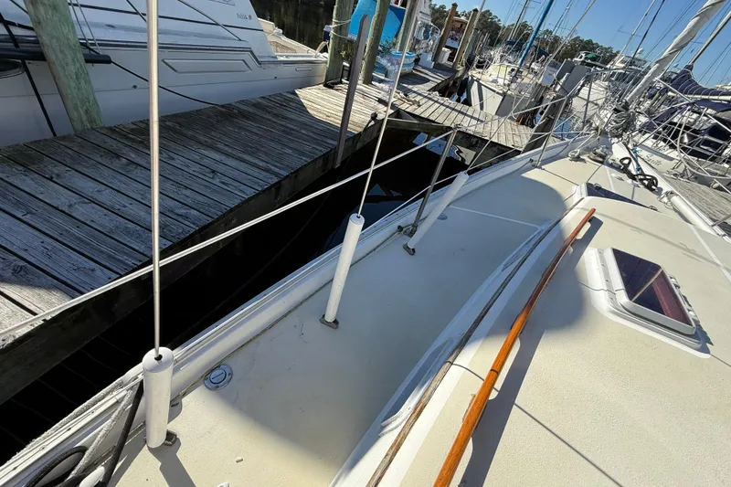 Slide: The Image of 1985 Niagara sailboat docked at marina, showcasing deck and rigging. - 8
