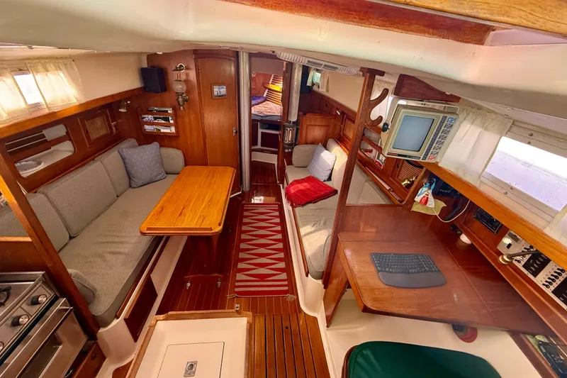 Slide: The Image of Interior of 1985 Niagara Encore sailboat with cozy seating and wooden furnishings. - 9