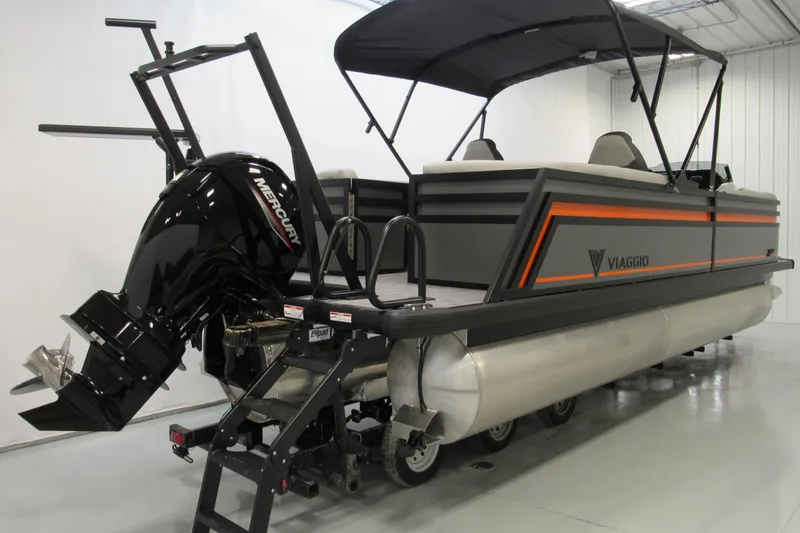 Slide: The Image of 2026 Viaggio Lago X22U pontoon boat with Mercury outboard motor in showroom. - 2