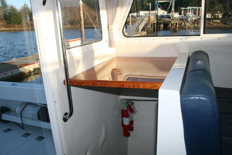 Slide: The Image of Interior cabin of a 2005 Ocean Sport 30' boat with blue cushions. - 10