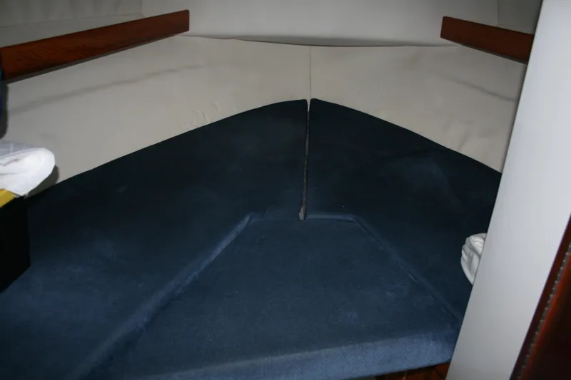 Slide: The Image of Interior cabin of a 2005 Ocean Sport 30' boat with blue cushions. - 14