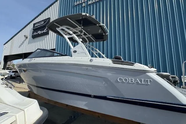 Slide: The Image of 2026 Cobalt R6 boat displayed outside a marine dealership. - 11
