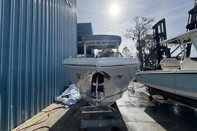 Slide: The Image of 2026 Cobalt R6 boat docked outdoors under bright sunlight. - 12