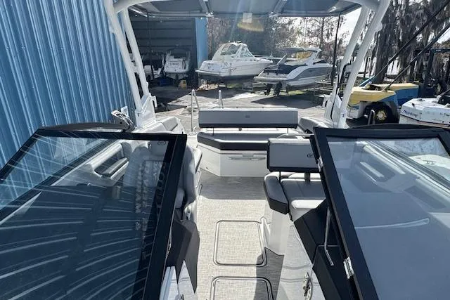 Slide: The Image of 2026 Cobalt R6 boat interior with open cockpit and seating, docked near other boats. - 23