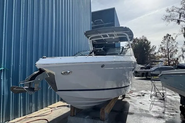 Slide: The Image of 2026 Cobalt R6 boat docked near blue building, sunny day. - 3