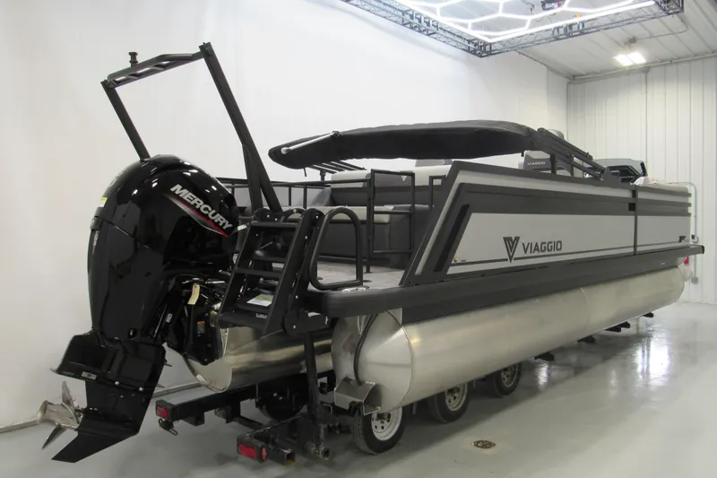 Slide: The Image of 2026 Viaggio Lago X22S pontoon boat with Mercury engine in a showroom. - 2
