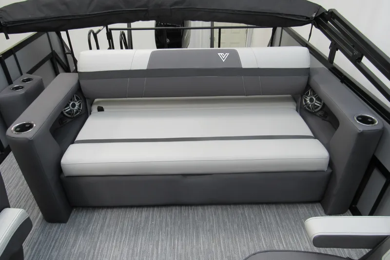 Slide: The Image of 2026 Viaggio Lago X22S boat interior with gray and white seating, cup holders, and speakers. - 11