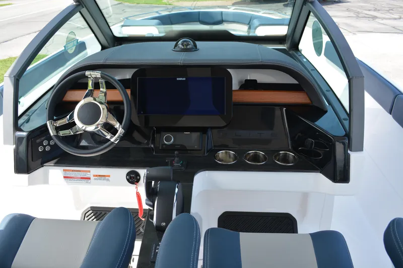 Slide: The Image of 2026 Monterey Elite 27 OB boat dashboard with steering wheel and digital display. - 10