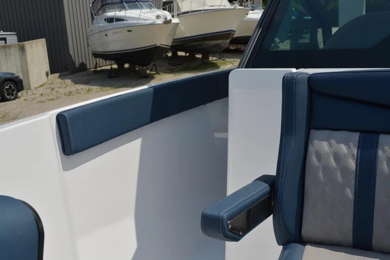 Slide: The Image of Interior of 2026 Monterey Elite 27 OB boat with blue and gray seating. - 17