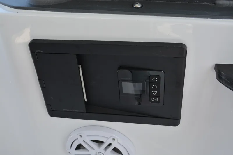 Slide: The Image of Control panel on 2026 Monterey Elite 27 OB boat, featuring buttons and a speaker. - 20