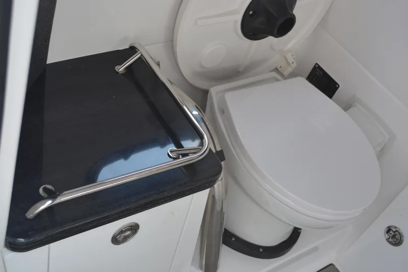 Slide: The Image of Interior of 2026 Monterey Elite 27 OB boat bathroom with toilet and countertop. - 23